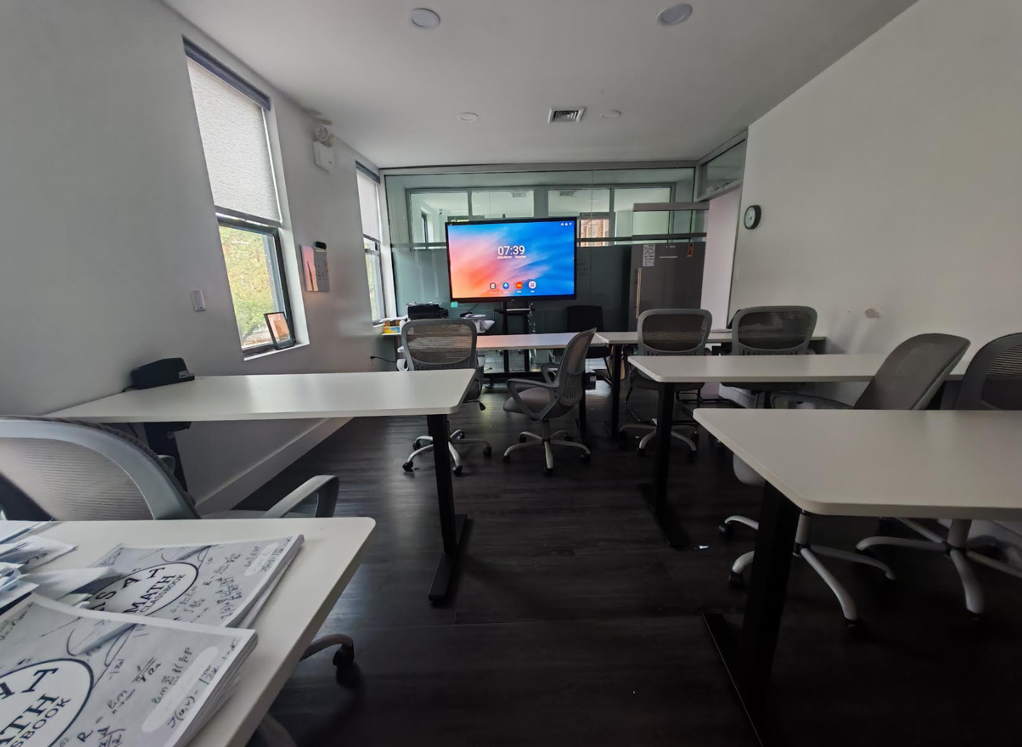 ToIvy math classroom with adjustable-height desks, ergonomic chairs, smart display, and natural light from large windows