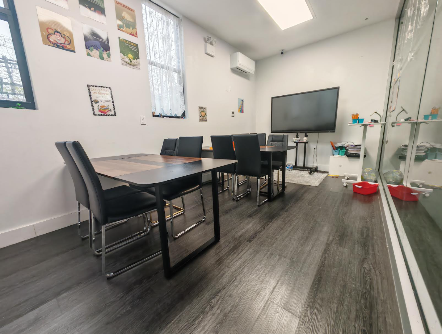 ToIvy reading classroom with literature posters on the wall, large interactive smart display, and seating for small-group discussion